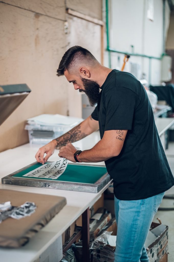 Photo of a man preparing a screen print.